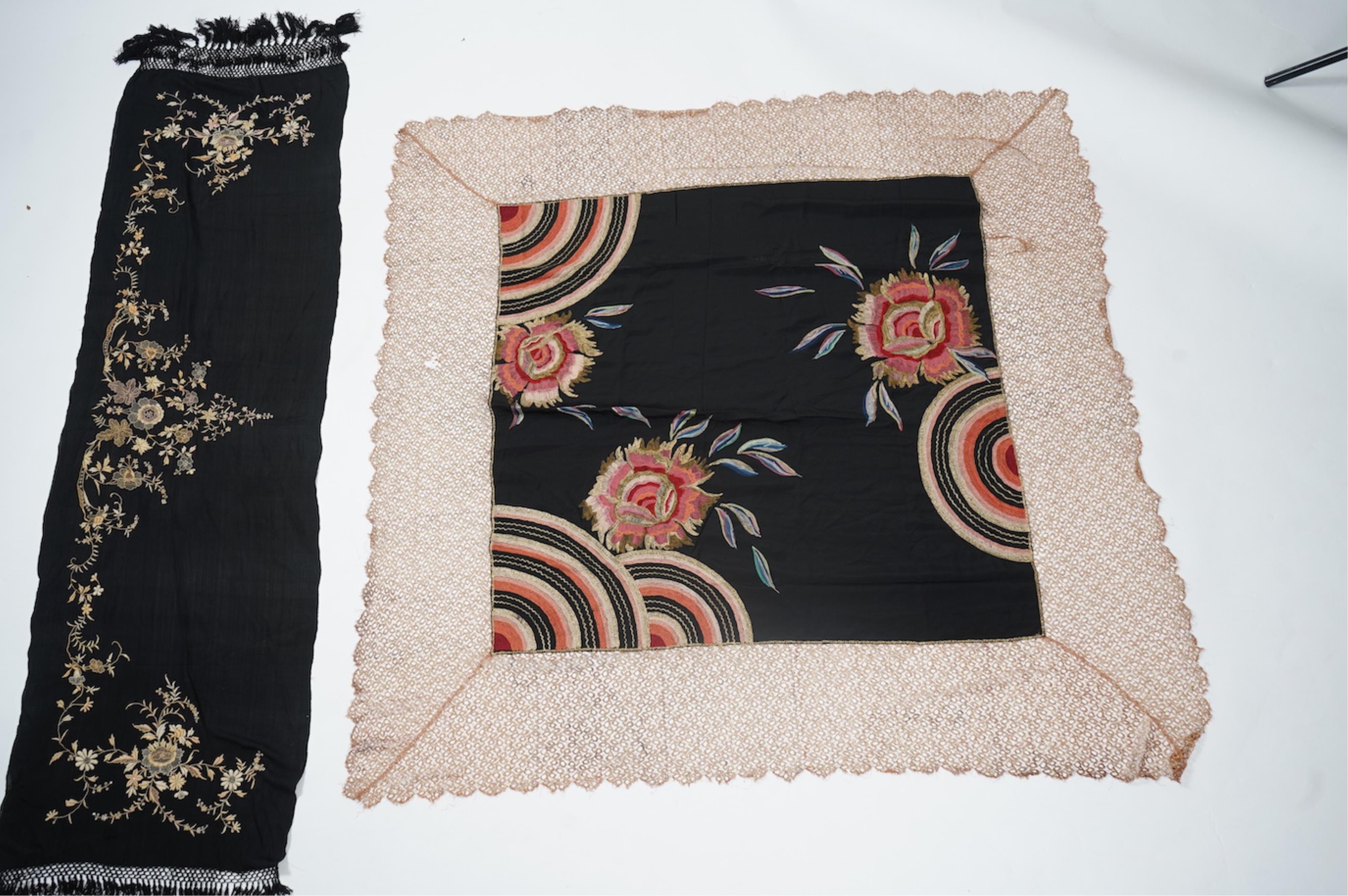 An Art Deco black silk floral embroidered shawl, using tones of red and orange with gold highlights, bordered with bronze metallic lace, together with a black crepe and yellow silk embroidered stole. Art Deco stole, 142c